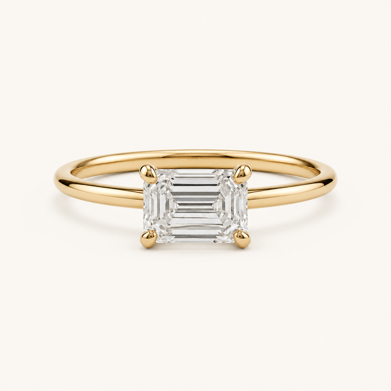 East-West Emerald Solitaire Diamond Ring in Yellow Gold